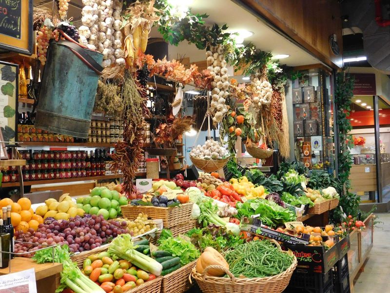 Stroll through stalls showcasing local vendors' goods at Mercato Centrale in Florence. 