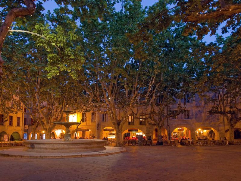 Place Aux Herbes in Uzès is a square filled with shopping, dining and dwellings. It's in the Languedoc-Roussillon region of southern France.