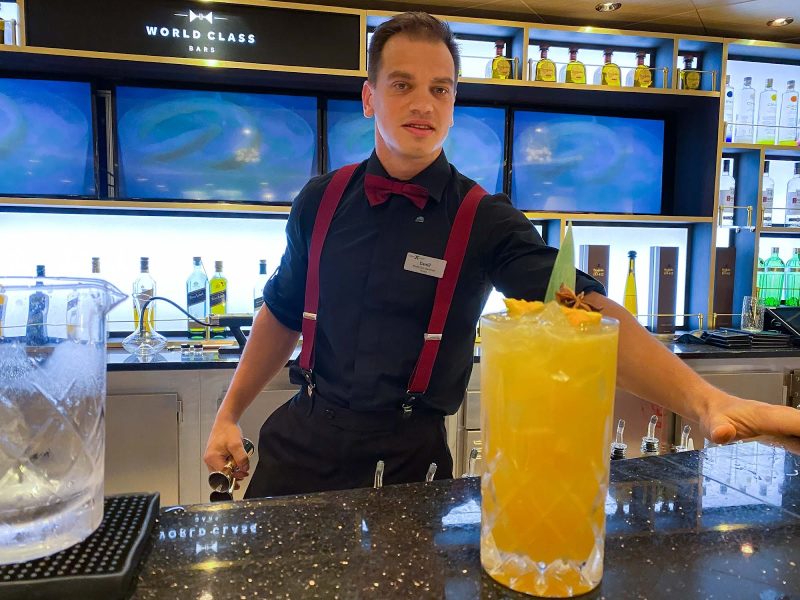 A Celebrity Cruises mixologist makes a QB Cooler for a guest.
