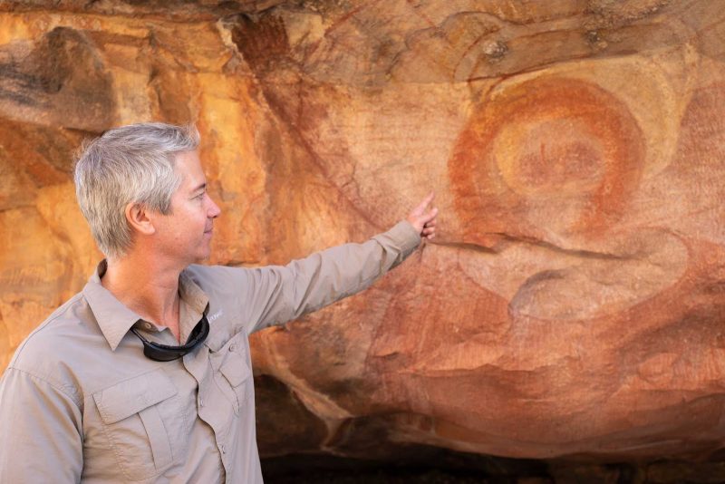 A tour guide explains the origins of aboriginal rock art in the Kimberley region of Australia on a Ponant cruise.