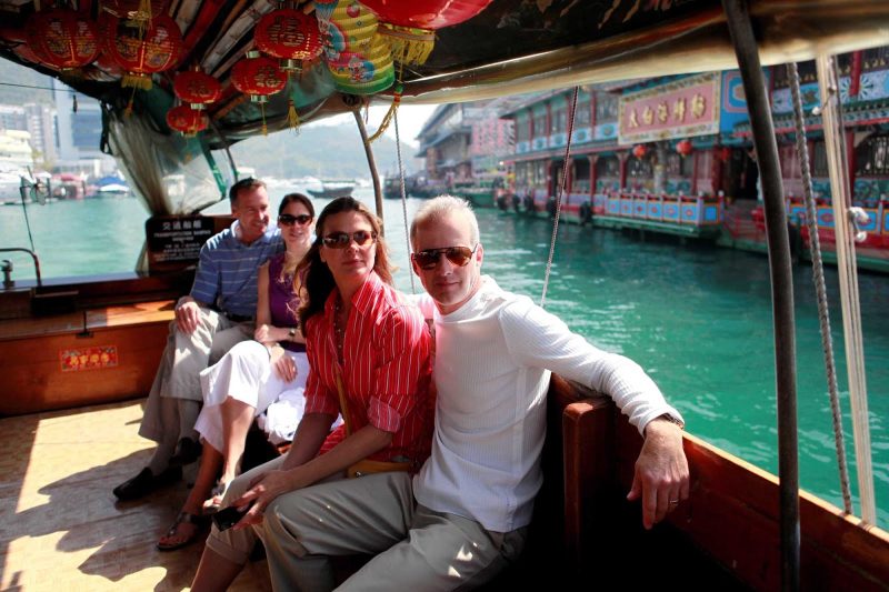 Visitors on a tour boat sail through Aberdeen, Hong Kong.