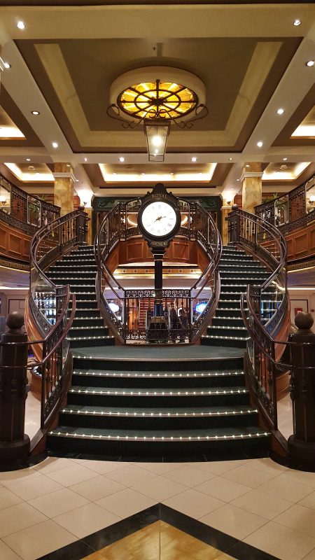 The Queens Arcade on deck 3 of Queen Victoria, inspired by the Royal and Burlington Arcades in London, features a grand staircase.