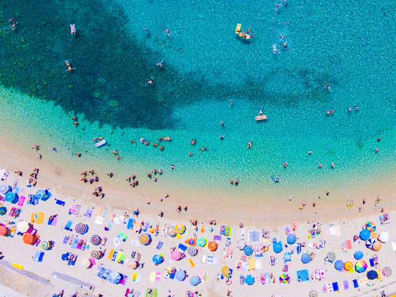 People sunbathing on the beach on Corfu island in Greece.