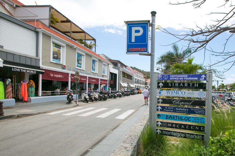 Signs pointing to key properties on the main street of Gustavia, St. Barts.