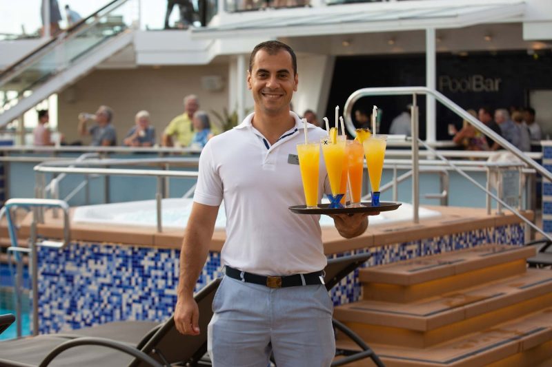 Fabian, a bar server from Albania, on the pool deck of Celebrity Equinox.