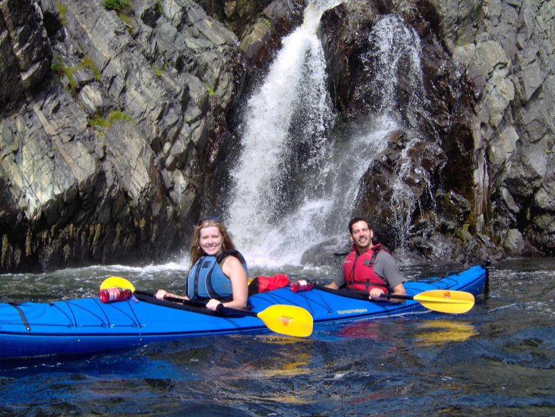 Kayakers in search of whales and waterfalls in Witless Bay, eastern Newfoundland.