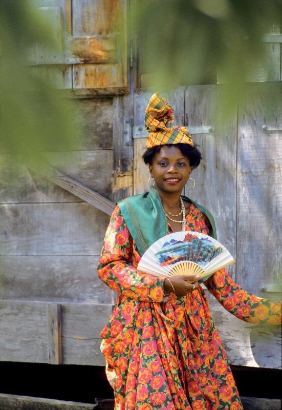 A young woman wears a traditional Creole costume at La Grivelière on Basse Terre, Guadeloupe.