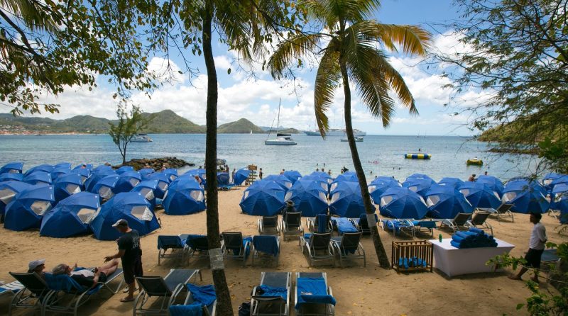 Windstar umbrellas and cots set up for a beach barbecue on Pigeon Island, St. Lucia.