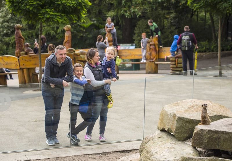 Family enjoying a day out at Edinburgh Zoo in Scotland.