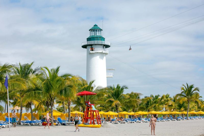 A zipliner zips across the beach and surf at Harvest Caye, Norwegian's private island in Belize.