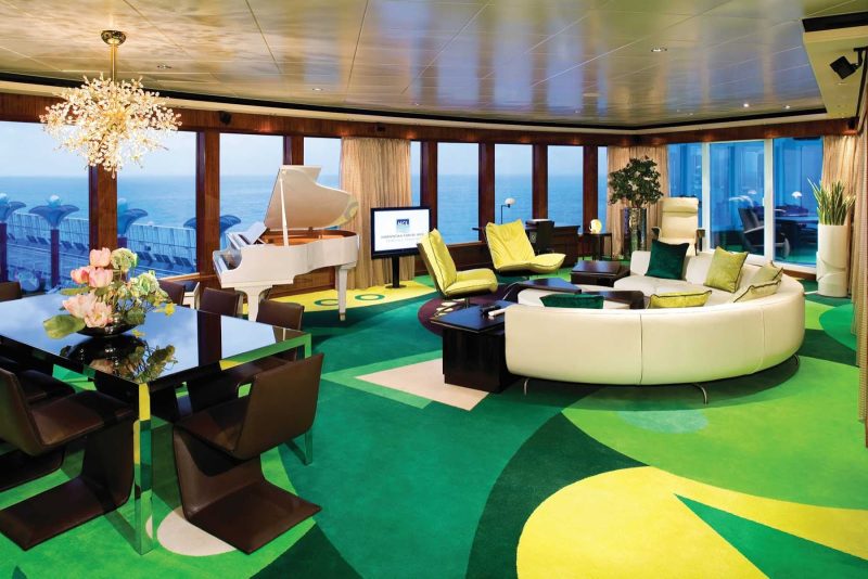The spacious living room of Norwegian Gem's 3-bedroom Garden Villa even has a piano.