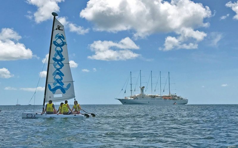 A Sandals sailboat takes in Windstar's Wind Surf on Pigeon Island, St. Lucia.
