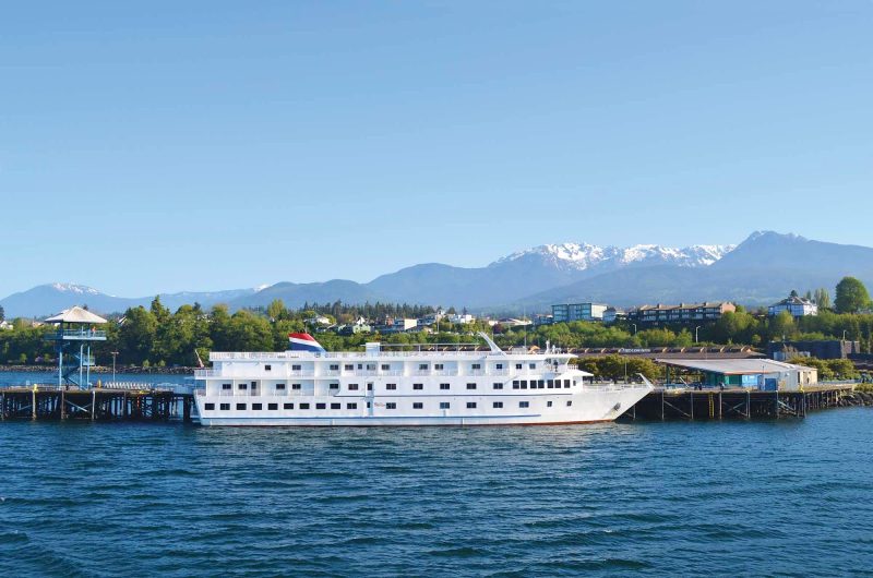 The American Star docked in Port Angeles, Wash., with a view of the Olympic Mountains in the distance. 