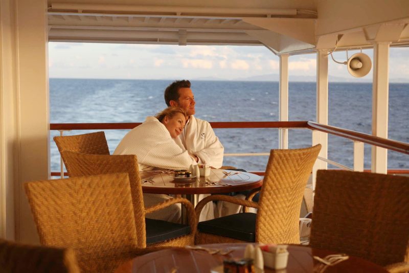 Watch the sun rise with your companion on a SeaDream cruise.