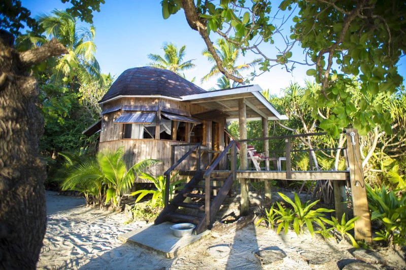 Relax on Tonga in huts that blend with the jungle terrain.