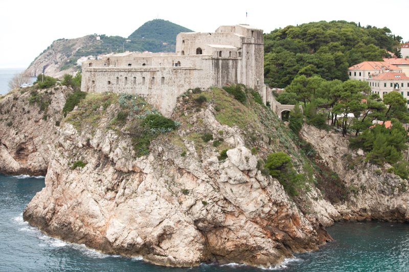A close-up of the fortress atop a promenade guarding Dubrovnik.